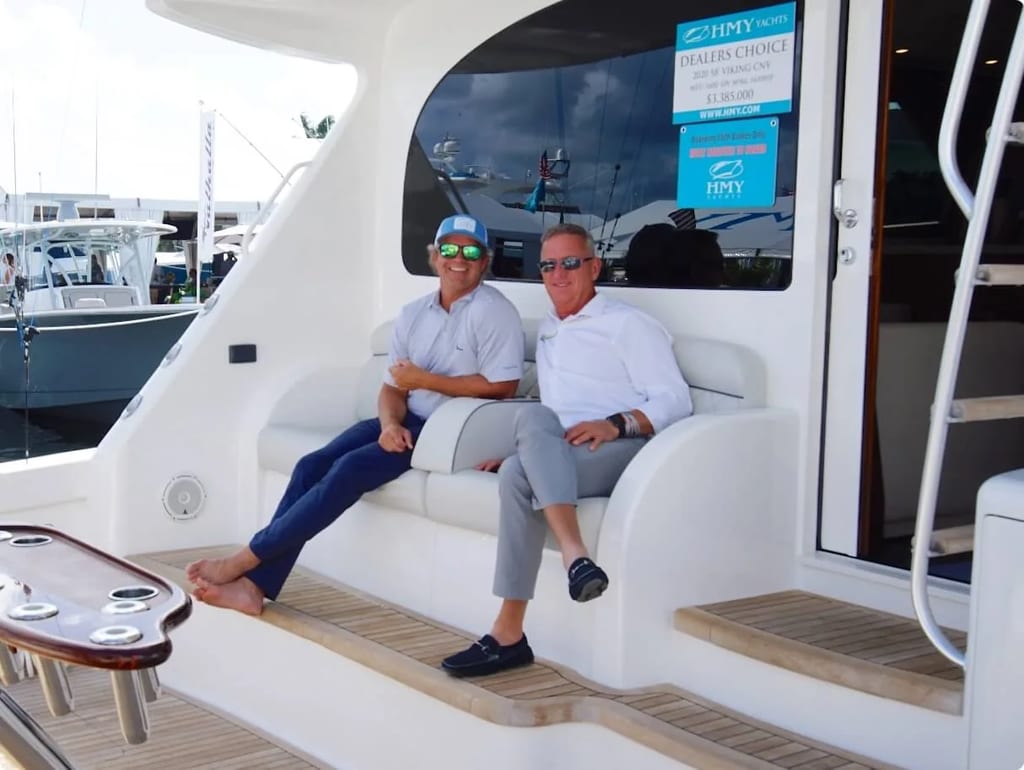 HMY brokers relaxing on the cockpit lounge of a Viking 58 Convertible at a boat show