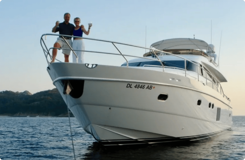 Two yacht owners standing on the bow of a motor yacht at anchor during a From the Flybridge podcast taping.