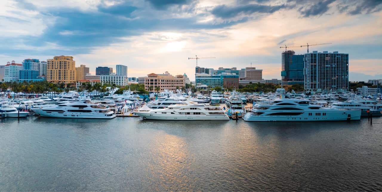 Aerial view of motor yachts and superyachts at a South Florida marina at sunset.