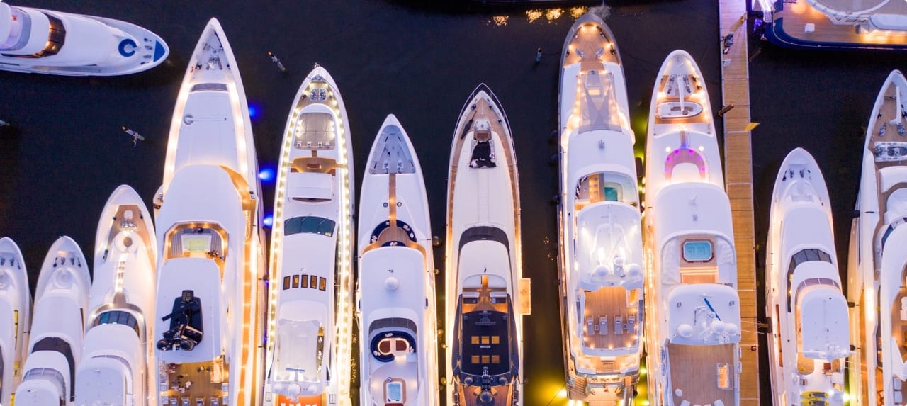 Fort Lauderdale's Intracoastal Waterway lined with luxury waterfront estates, yachts, and tropical landscaping