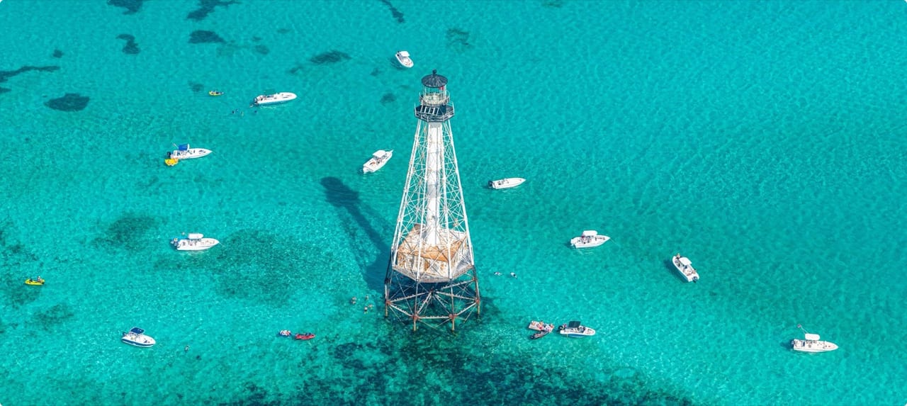 Aerial view of the Overseas Highway stretching across the Florida Keys with turquoise and deep blue waters on each side