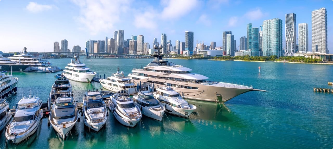 Aerial view of Miami's coastline with turquoise Atlantic waters, white sand beaches, and the downtown skyline in the distance