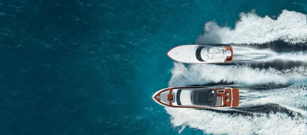 Aerial view of two motor yachts cruising on blue water