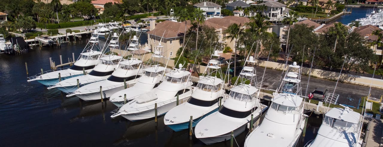 Sportfishing yachts moored side by side along a shared marina dock.
