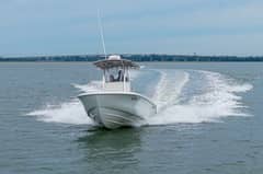 2023 24' 6" Contender 24S - Center console boat with hardtop running on the water, bow view