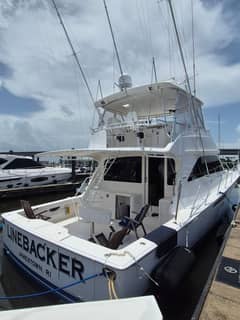 2006 57' 5" Viking 56 Convertible - Stern quarter view of a white convertible sportfish yacht moored at a dock