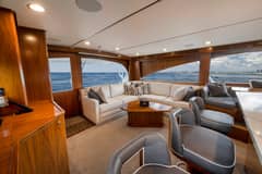 2020 Viking 68 Convertible - Salon interior with L-shaped sofa, coffee table, bar stools and large windows