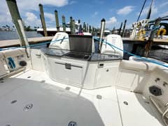 2024 41' 1" Boston Whaler 405 Conquest - Cockpit aft station with grill and storage compartments, outboard engines mounted on