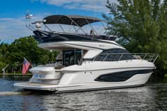 2025 47' 1" Princess F45 - Flybridge motor yacht underway on calm water, viewed from port quarter