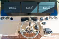 2017 42' 1" Scout 420 LXF - Helm station with steering wheel and three Garmin multifunction displays