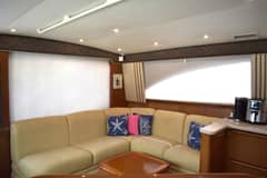 2006 Ocean Yachts 42 Super Sport - Salon interior with L-shaped settee, throw pillows, cabin windows with blinds and