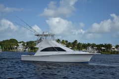 2006 Ocean Yachts 42 Super Sport - Starboard profile of a white sportfishing convertible underway with outriggers raised