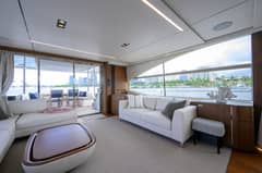 2022 Princess Y78 - Salon interior with sofas, coffee table and large side windows