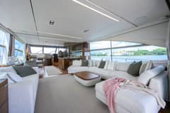2022 Princess Y78 - Salon interior with sectional seating, coffee table and large side windows