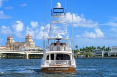 2024 Viking 64 Convertible - Stern view of a sportfishing yacht underway with tuna tower and flybridge