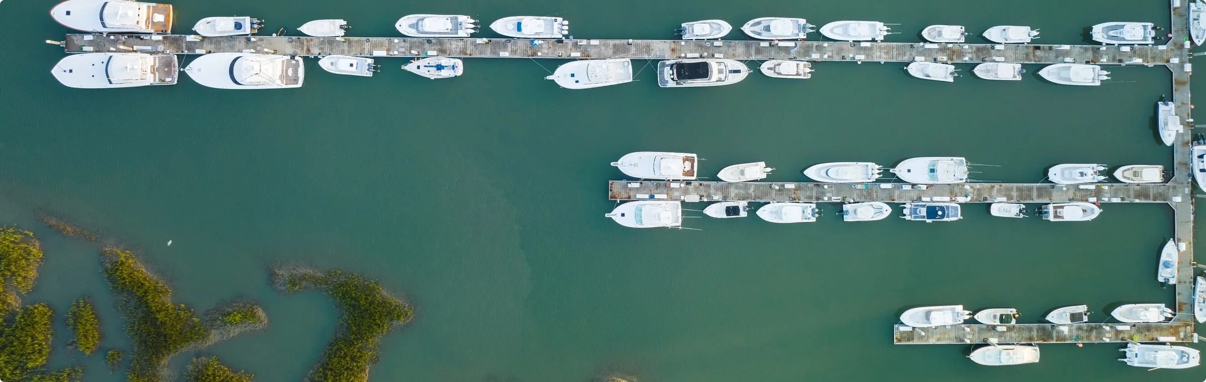 Aerial view of HMY-listed yachts docked at a marina