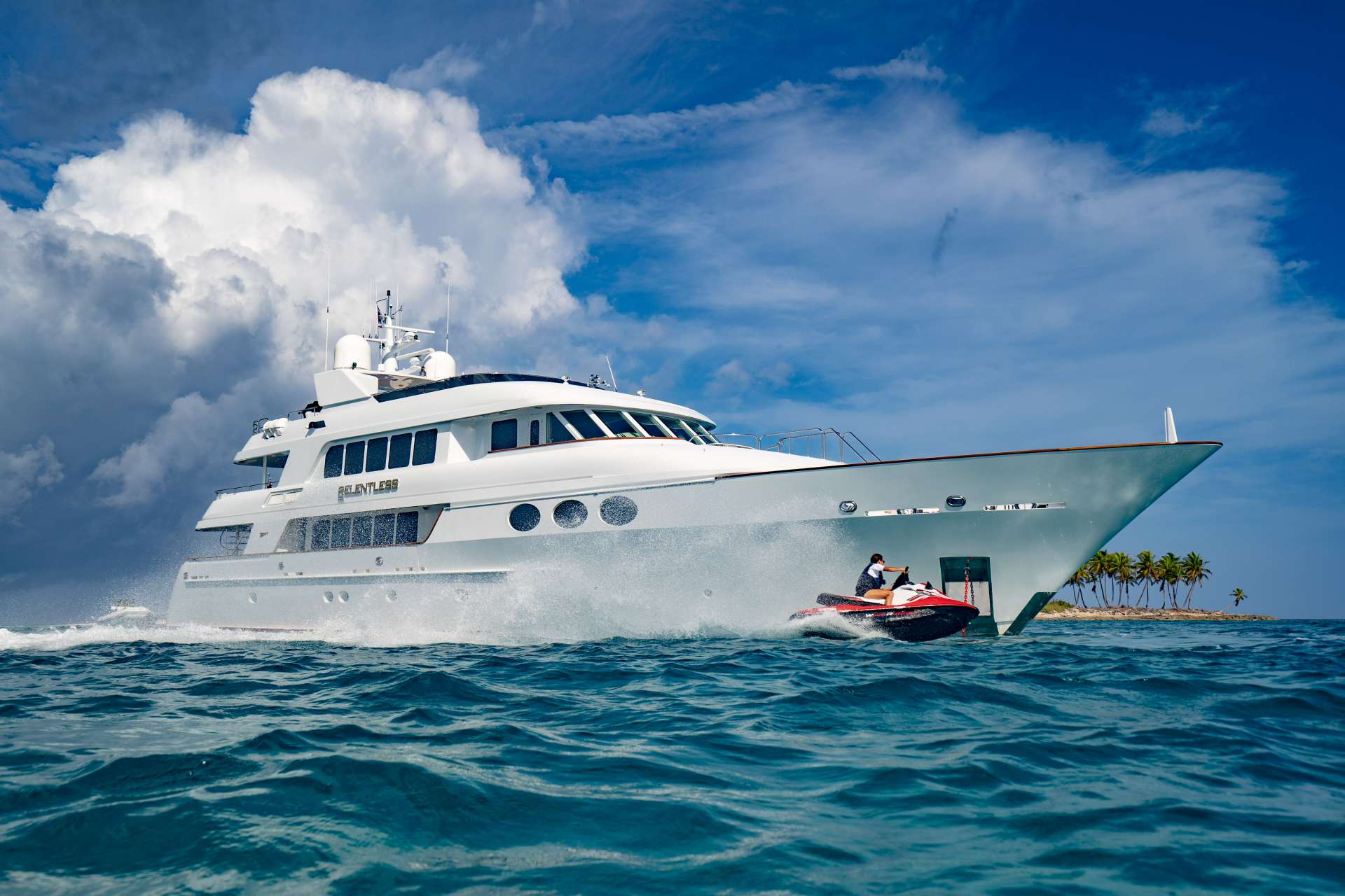https://charteryachtrelentless.com Elegance meets power with this solid and artfully constructed 145′ Trinity Yacht. After chartering her for five years, the current owners purchased Relentless in late 2018 and have enjoyed upgrading and refitting her. Come relax in the impeccable craftsmanship of her exquisitely designed, soft beige and gold-accented interiors. Opulent dining, spacious interiors, and panoramic views will take your breath away… pampering awaits. Her main salon includes a sit-down bar aft, salon area with entertainment and a separate private formal dining room where the chef’s culinary creations are waiting to delight. Relentless features five lavish staterooms including a king master suite located on deck with his and hers bathroom to include a large shower and Jacuzzi tub. Four additional guest staterooms are located below, which include two king staterooms, one queen and one twin, all with en-suite bathrooms, full entertainment systems and large closets for storage. The sky lounge offers a comfortable gathering area to watch movies, enjoy afternoon treats from the chef and is a popular guest area. Step outside to experience our three spacious decks and submerge yourself in 360 degrees of breathtaking vistas. All decks feature ample seating, tables and chairs for socializing and dining. The spacious sky lounge deck features a large round table where many theme parties are held. The crew of Relentless have a huge assortment of fun filled themes from fun to formal and anything in between. If you’re feeling invigorated, Relentless offers a treadmill and full assortment of gym equipment for outdoor exercise on the newly refit flybridge. The flybridge was reconfigured with a new Jacuzzi, wraparound sun beds, lounging furniture and new sit-down bar as well as a movie night option under the stars. Relentless offers a full list of water toys for your fun and adventure and has a proven charter crew of 9.