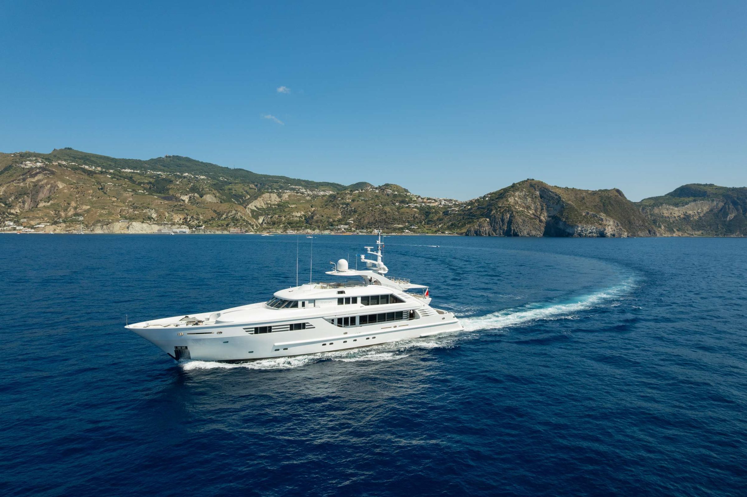 Penelope is a majestic 48.00 superyacht built by Isa Yachts in 2005 and refitted in 2024-2025. She boasts superb volume wisely arranged, in order to exploit living areas at their best and delight the most discerning guests. The yacht boasts a thoughtfully designed night layout, accomodating up to 12 guests in 6 exquisite cabins. The full beam master cabin is located on the main deck and features 2 lavish marble bathrooms (one with shower, one with bathtub). The guest accommodation area is located on the lower deck across two double cabins at the stern, two mid-ship twin cabins and one vip cabin forward, all with ensuite facilities. Penelope’s interiors are characterized by stylish lines. The spacious main saloon features an ample dining table and a generous aft lounge area. Rising to the upper deck, guests will find an additional huge saloon equipped with sofas and al fresco lounge and dining area. The exterior areas, styled by Walter Franchini, spread across three teak decks. The spacious sundeck is crowned by the wonderful Jacuzzi, the perfect spot for relaxing and spending long sunny days. Her experienced crew of 9 boast an extensive experience and ensure a first-class service and warm hospitality.