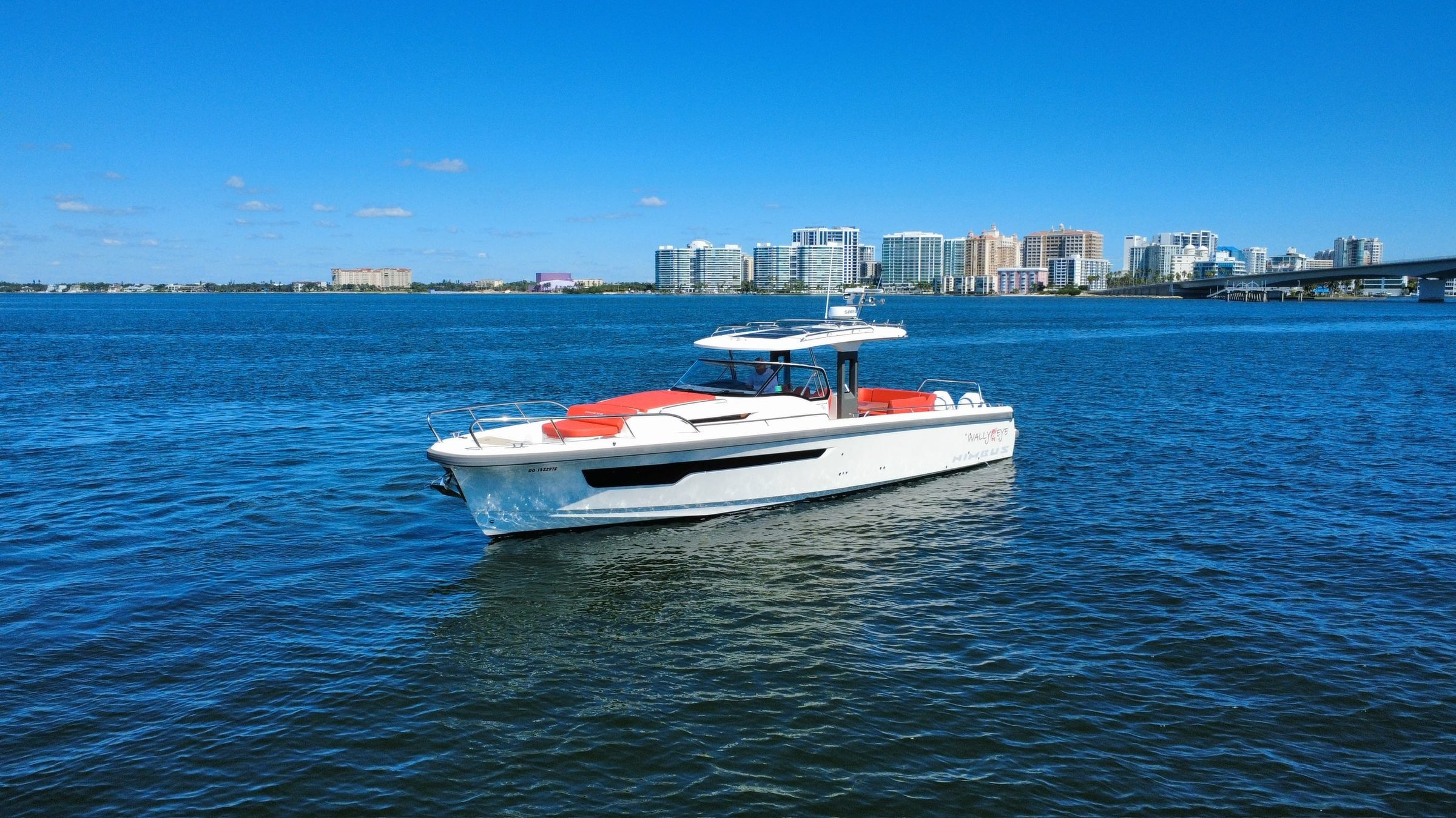 2022 40' 7" Nimbus T-11 - White outboard-powered motor yacht with hardtop and red cushions on calm water