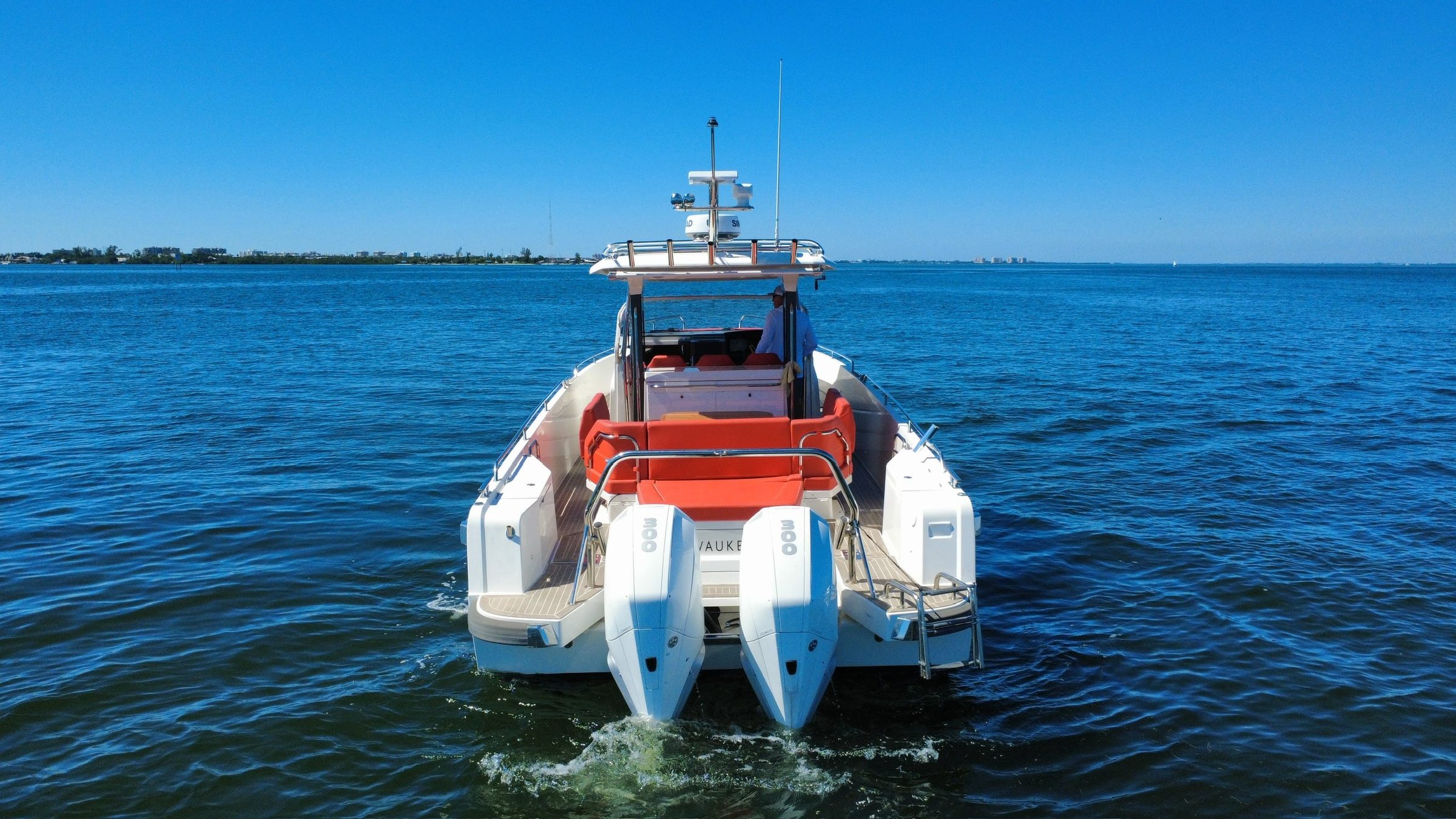 2022 40' 7" Nimbus T-11 - Stern view of a center console boat underway with twin outboard engines