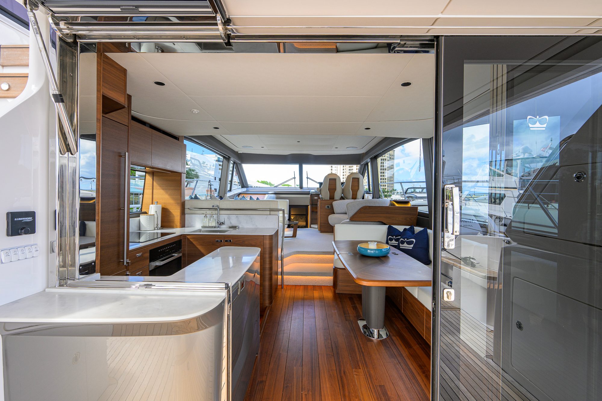 2026 Princess F58 - Salon interior viewed from aft, with galley, dinette and helm seating forward