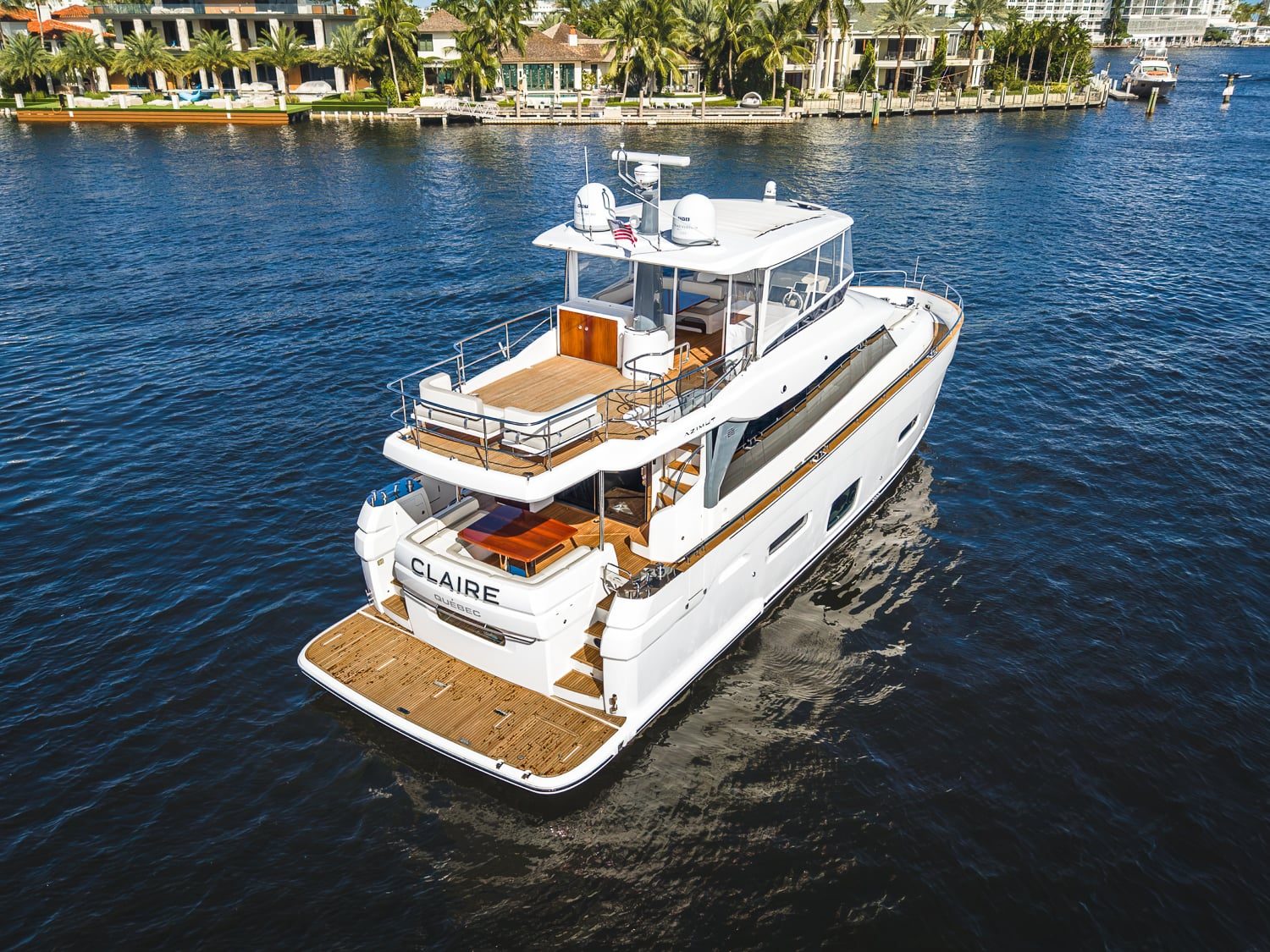 2018 66' 1" Azimut Magellano 66 - Aerial stern quarter view of motor yacht on water with swim platform and flybridge