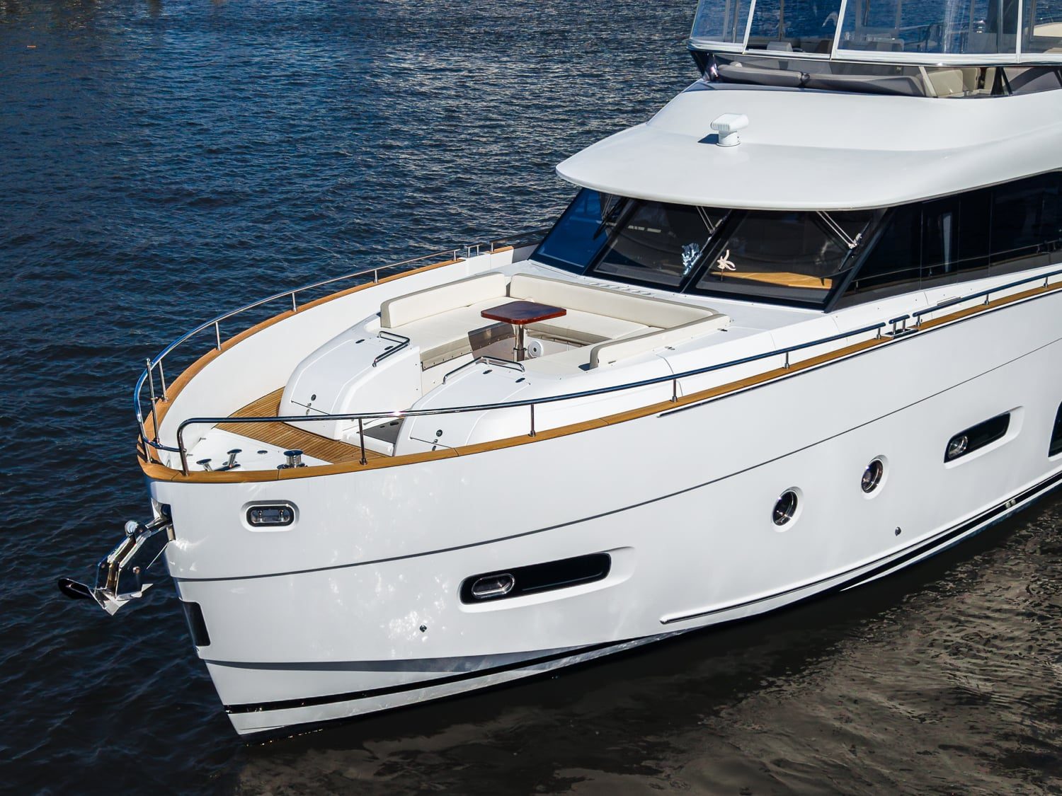 2018 66' 1" Azimut Magellano 66 - Bow of a white motor yacht with foredeck seating and table