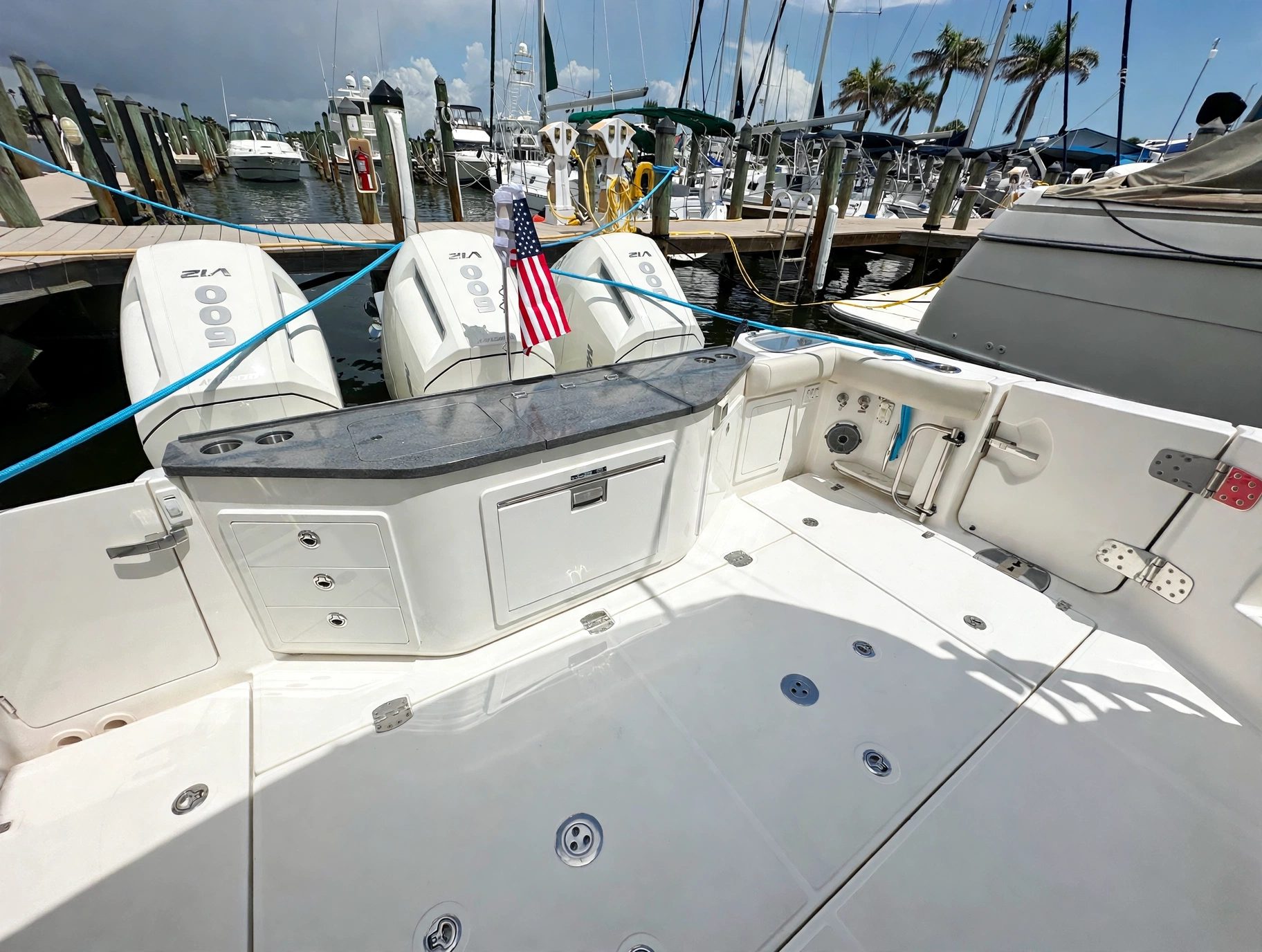 2024 41' 1" Boston Whaler 405 Conquest - Cockpit looking aft toward transom counter with triple outboard engines mounted