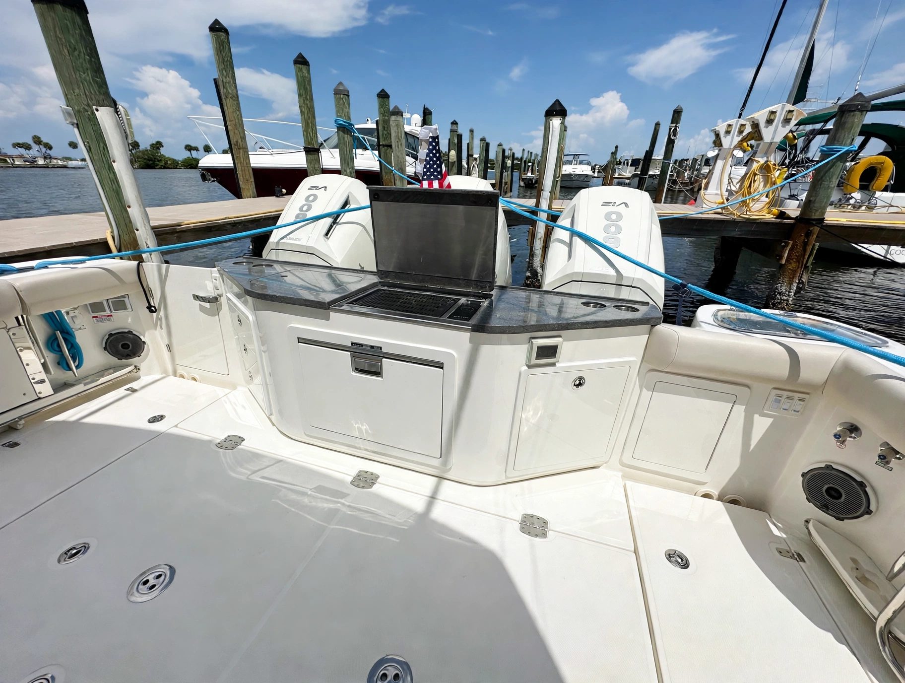 2024 41' 1" Boston Whaler 405 Conquest - Cockpit aft station with grill and storage compartments, outboard engines mounted on