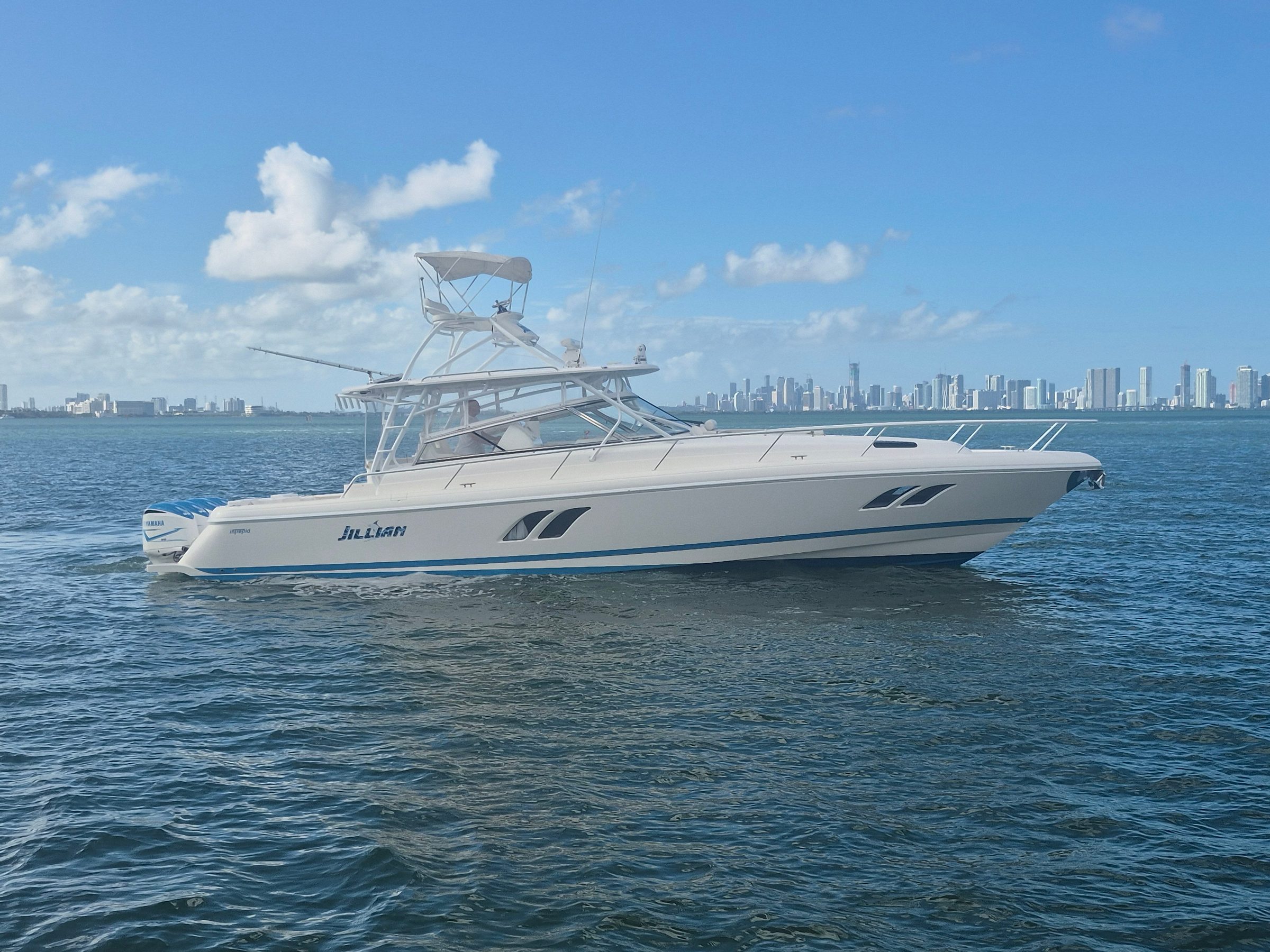 2018 47' 6" Intrepid 475 Sport Yacht - White sport fishing boat underway on open water, starboard profile view with tower and