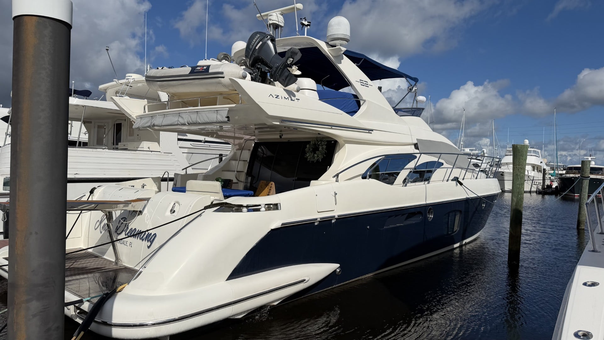 2009 63' 1" Azimut 62 Motor Yacht - Motor yacht moored stern-to at a dock, showing aft quarter and flybridge