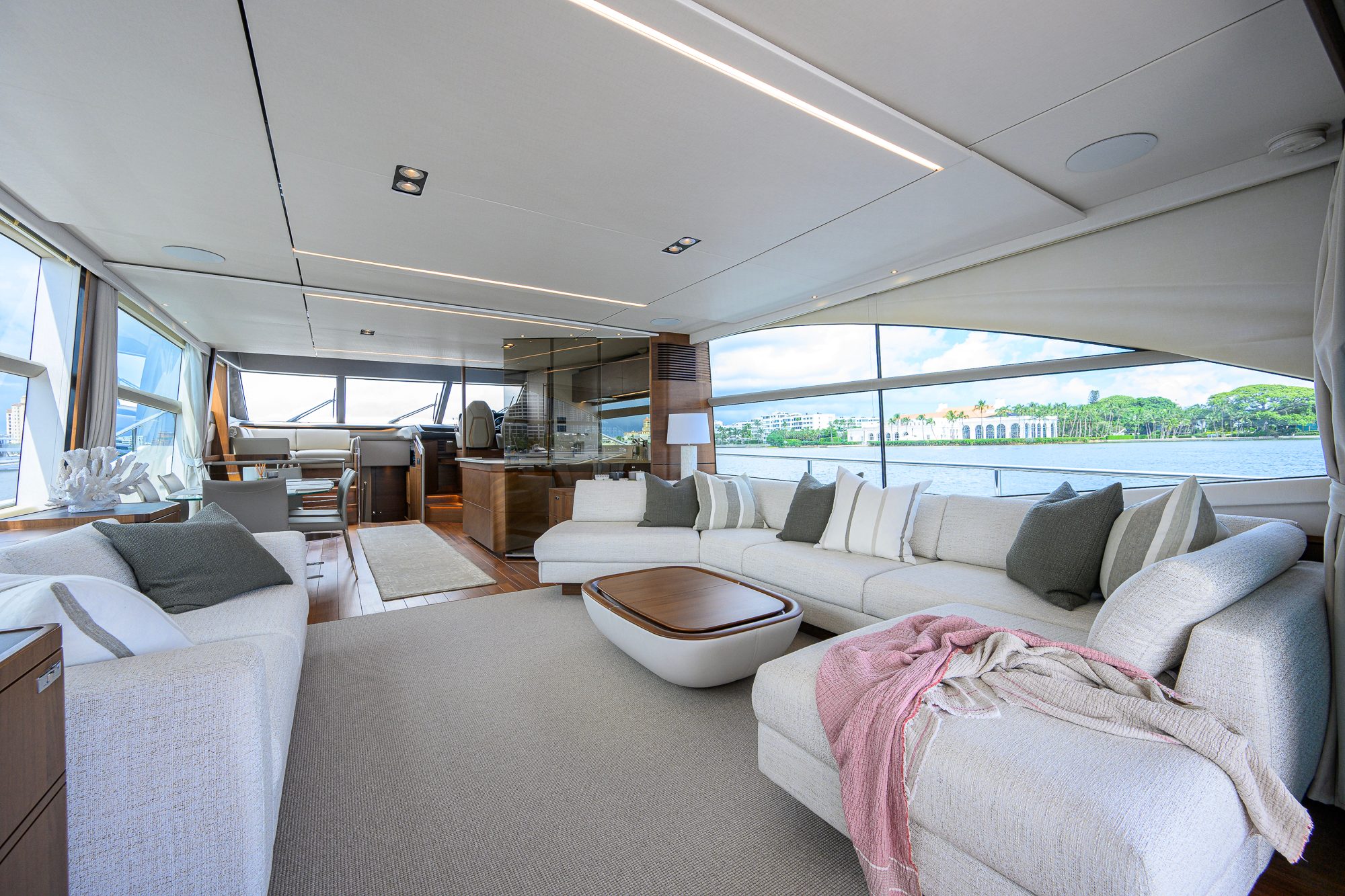 2022 Princess Y78 - Salon interior with sectional seating, coffee table and large side windows