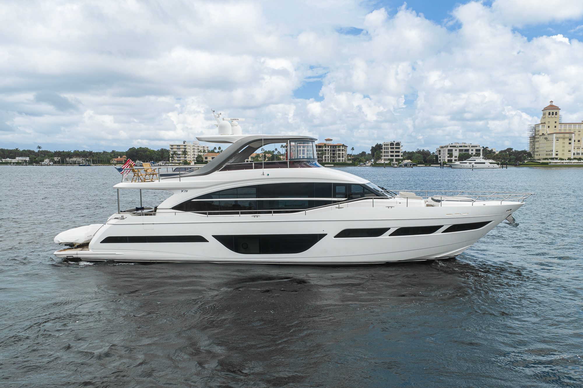 2022 Princess Y78 - Starboard profile of a white flybridge motor yacht underway on open water