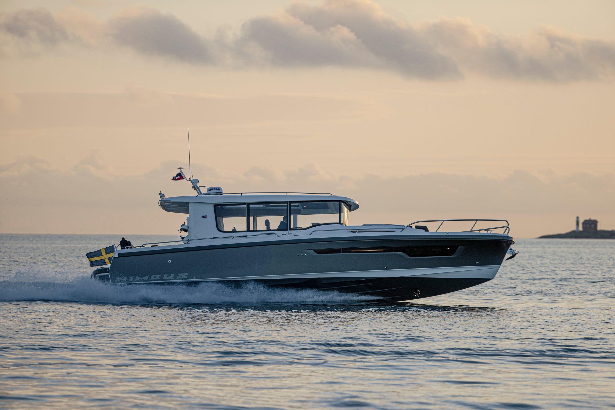 2027 Nimbus Sport Coupe 42 - Gray enclosed-pilothouse motor yacht underway on open water, starboard profile view