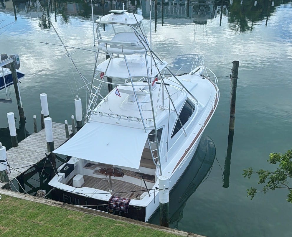 2022 Viking 44 Sport Coupe - Sportfishing convertible with tuna tower and outriggers moored stern-to at a dock