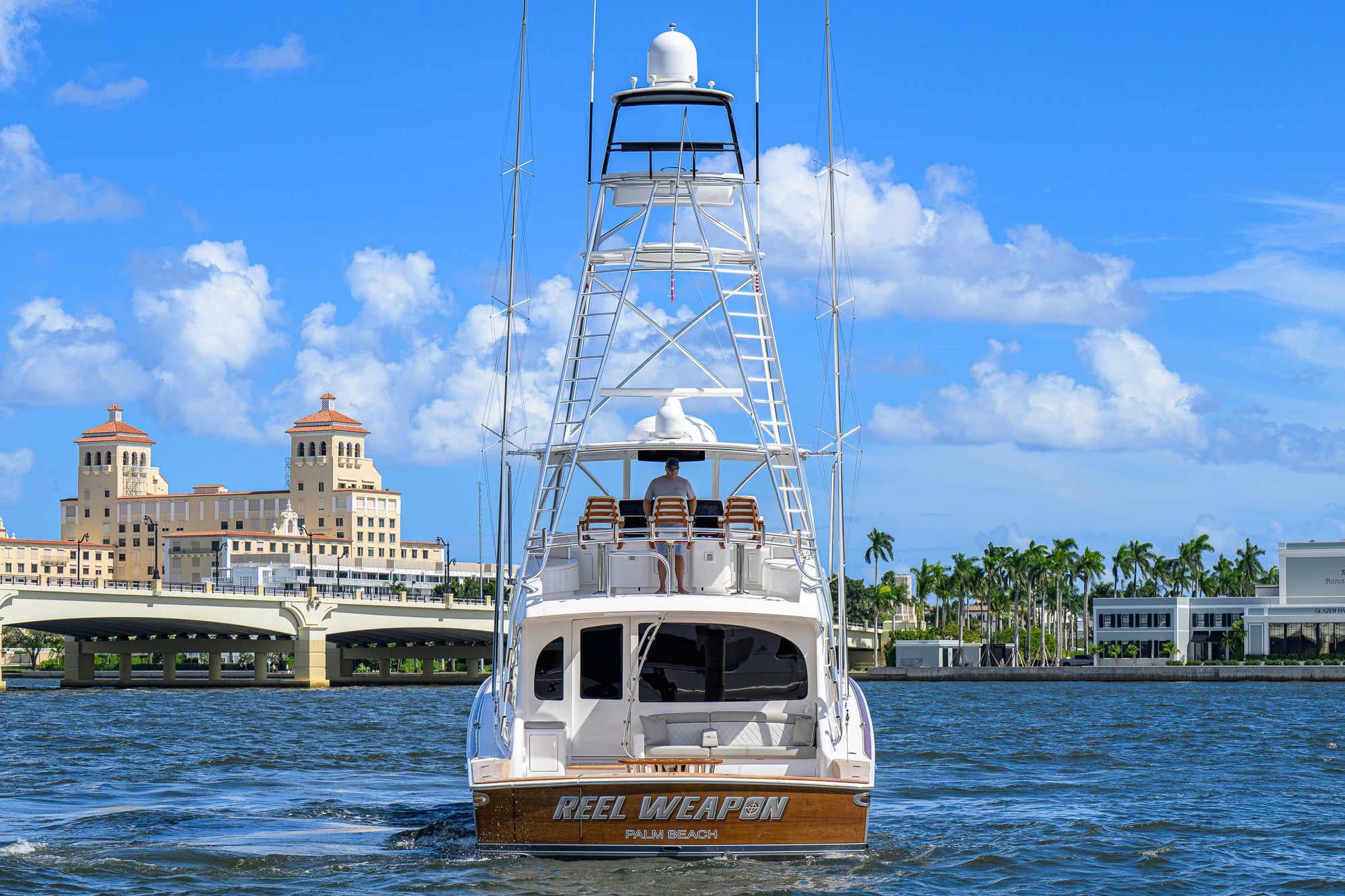 2024 Viking 64 Convertible - Stern view of a sportfishing yacht underway with tuna tower and flybridge