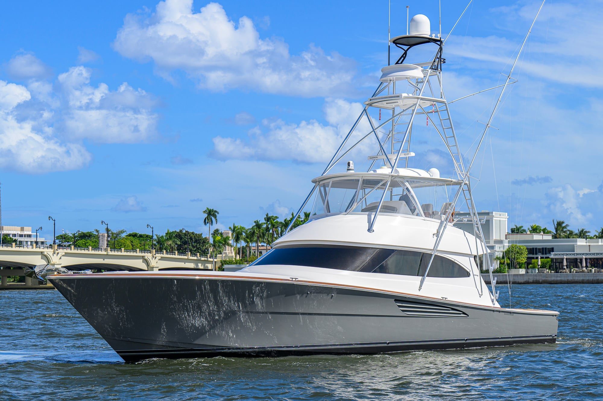 2024 Viking 64 Convertible - Sportfishing convertible yacht underway on the water, viewed from the port bow