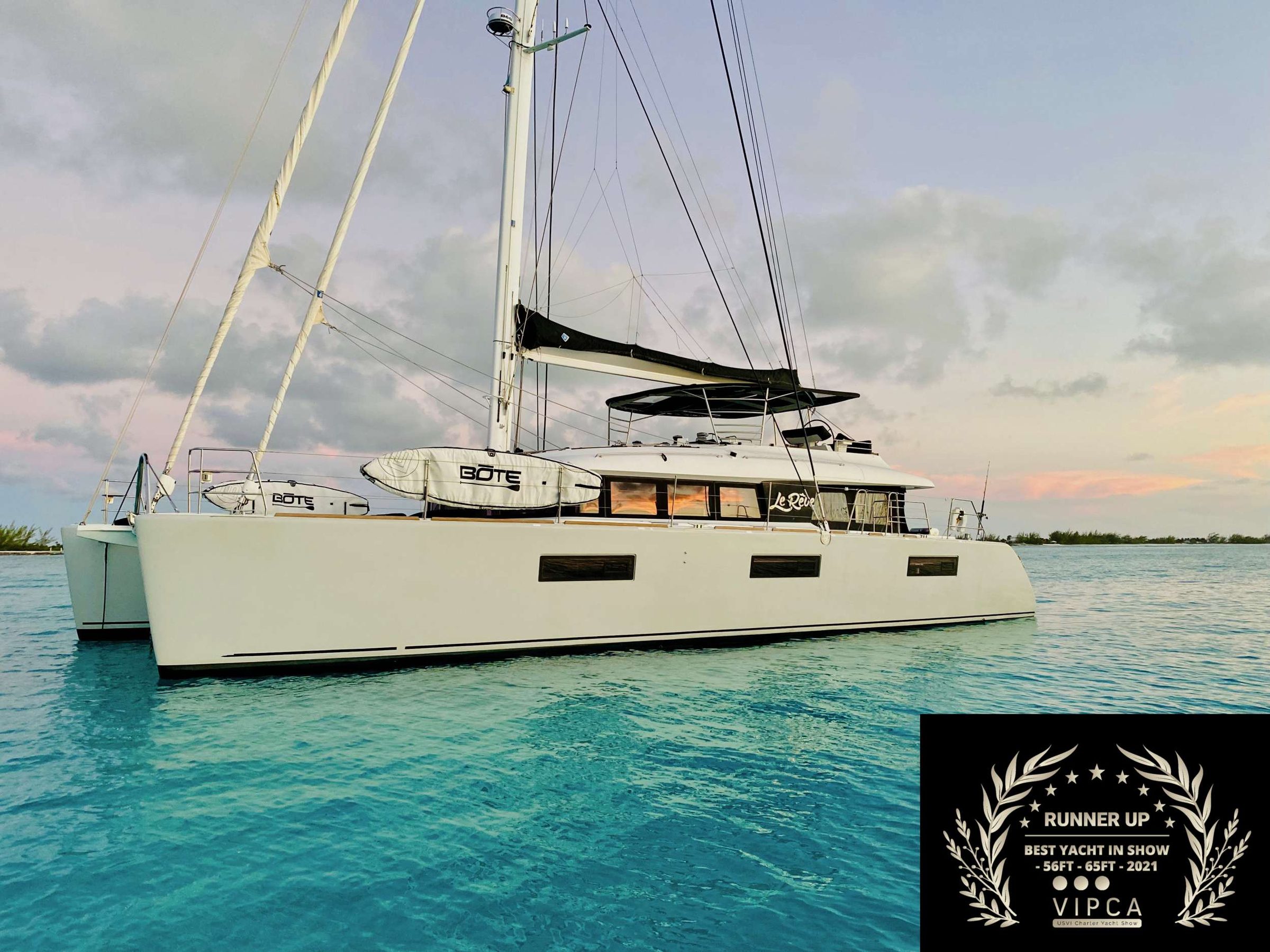 The beautiful Le Reve in the in the Virgin Islands, Bahamas, or New England.

Experience the art of living aboard Le Reve, an owner's edition of the Essence line that is the epitome of luxury.

The three spacious air-conditioned staterooms are fitted with high end materials and furniture that allow for a nearly unprecedented level of comfort. Guests can enjoy their gourmet meals in our luxurious cockpit seating area and then lounge with a cocktail on the massive sun-deck afterwards. The gull-wing bridge deck design allows for greater comfort and smoother sailing, despite heavy seas.

Le Reve is equipped with an impressive array of water equipment, including but not limited to skis, paddle boards, snorkeling gear, kiteboarding gear, and SCUBA with a compressor.

Despite the outstanding quality of life aboard, performance is not sacrificed. With its twin 150HP Volvo engines and 1500+ square foot mainsail, Le Reve can easily reach and maintain top speeds in a variety of conditions.