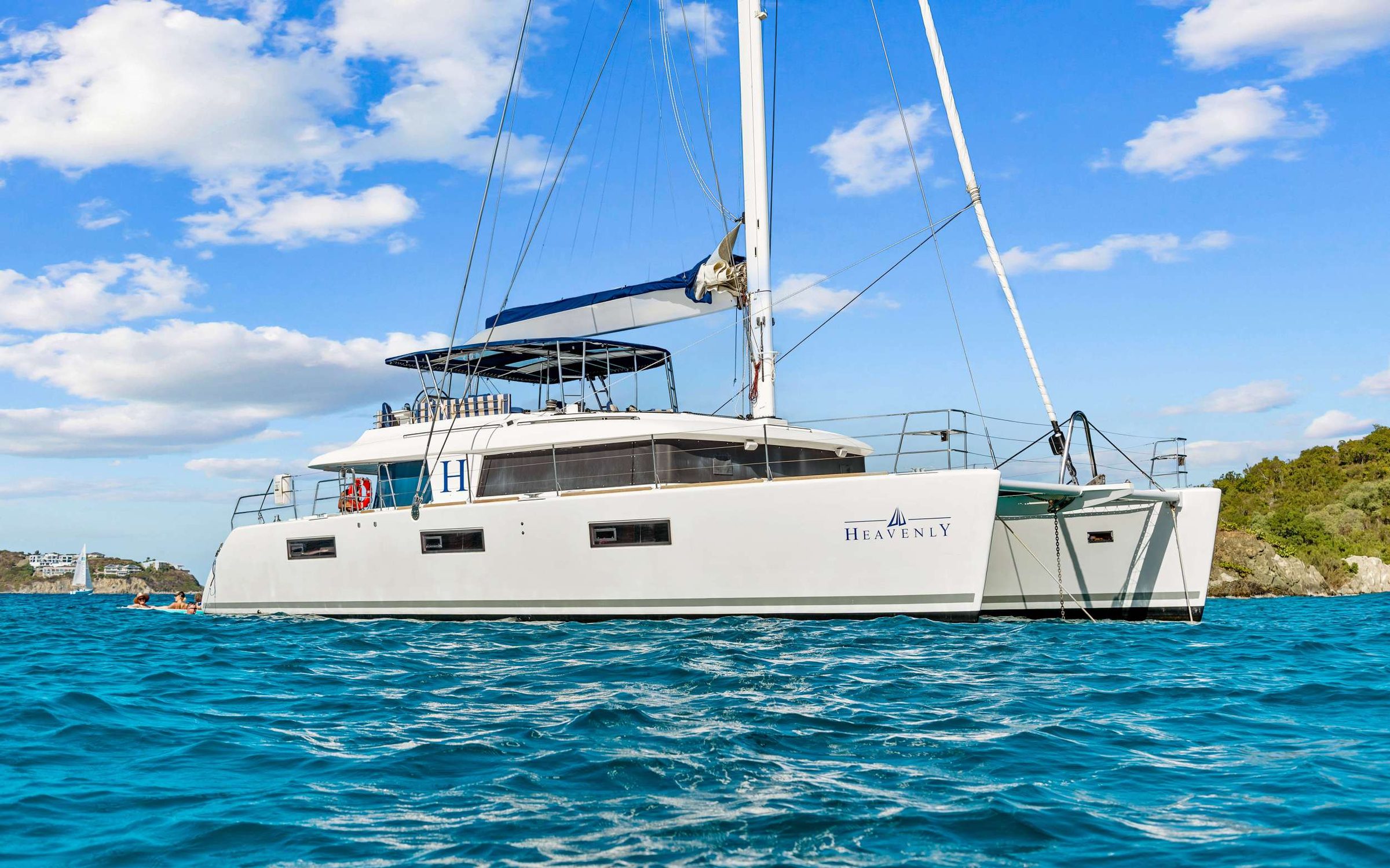 Fresh off the cover of Latitude & Attitudes&rsquo; May/June 2026 charter issue, HEAVENLY is a Lagoon 620 Luxury Edition sailing catamaran that pairs big-boat space with polished, resort-level comfort. Teak decks set the tone, with a cockpit dining table for 8 plus grill, beverage fridge, and ice maker for effortless island entertaining. Standout features: a flybridge social hub with 360&deg; views and front-row sail watching, and a bright panoramic salon with a guest-friendly galley-down layout. Sleeps 8 in 4 Queen cabins, each with a private ensuite, large windows, and in-cabin entertainment. Recently elevated with a $1M+ 2024/2025 refit&mdash; new tender, DIRECTV in salon, Starlink Wifi, new generator, A/C, Rainman watermaker, dual fridges, plus fresh Sunbrella cushions, interior upholstery, new bimini, linens, dishes, and more&mdash;HEAVENLY feels crisp, current, and undeniably posh. Robes, thoughtful touches, and pure &ldquo;ahh.&rdquo; HEAVENLY is divine.