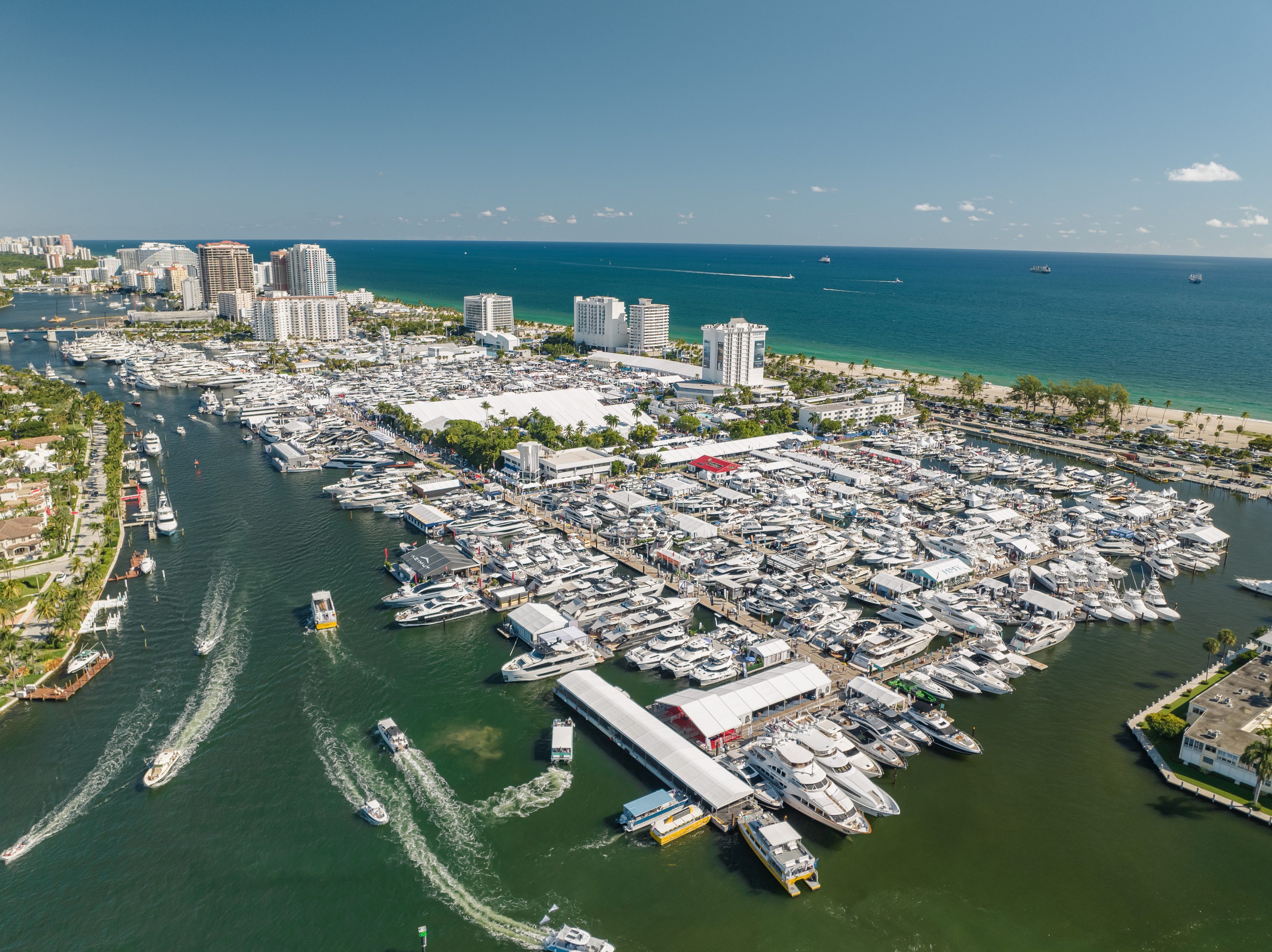 Yachts and exhibitor tents fill the Bahia Mar waterfront beside the beach at the Fort Lauderdale boat show.