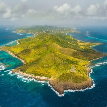 Secluded tropical beach on St. John with palm-fringed white sand and calm turquoise waters
