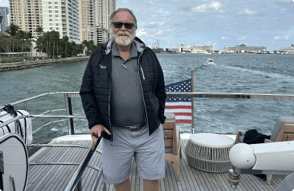 Steve Moynihan aboard a Princess yacht with the Miami skyline behind him.