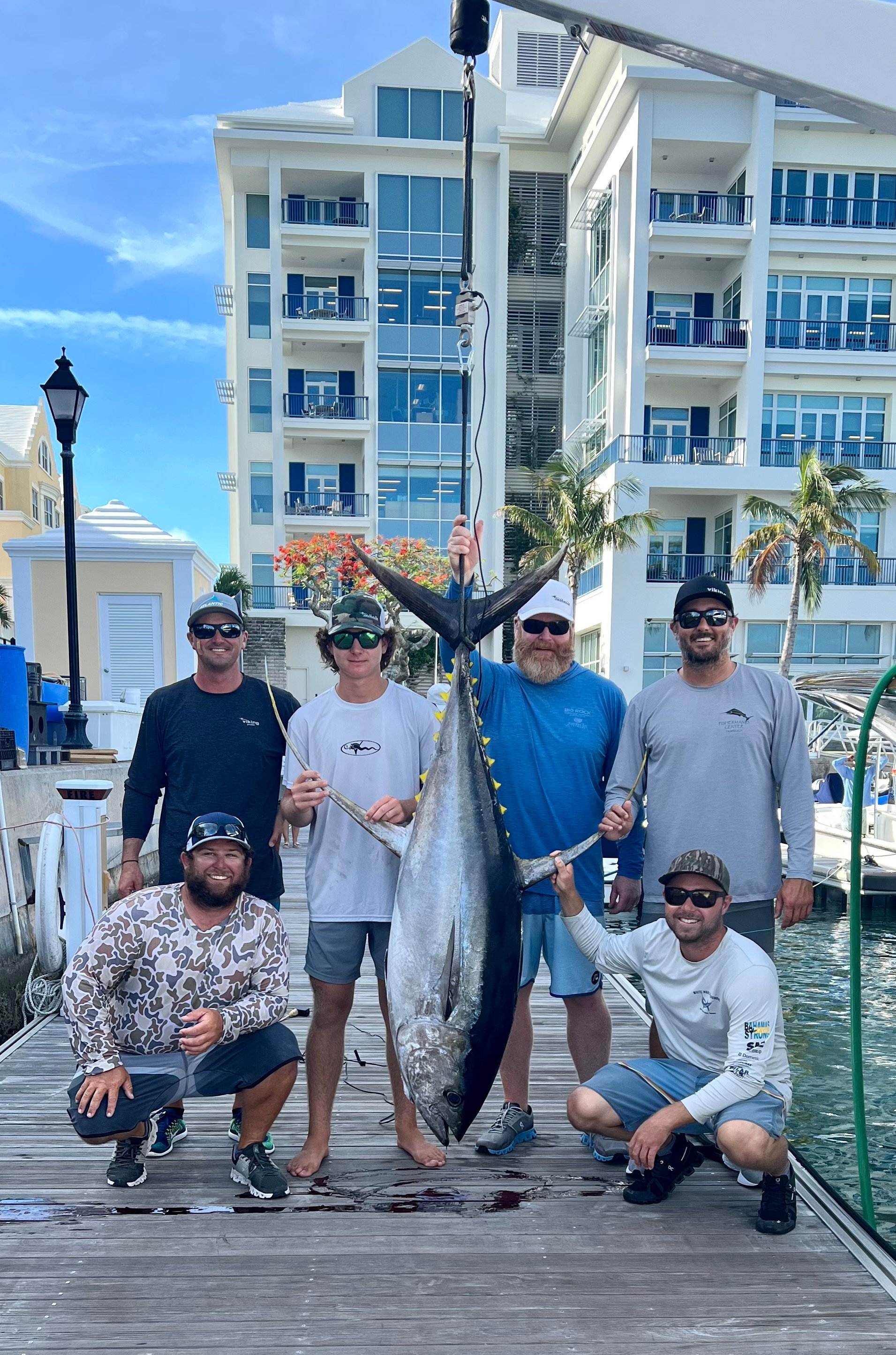 Tim and WIll Gredick and the Viking Yachts Demo crew with a yellowfin tuna. 