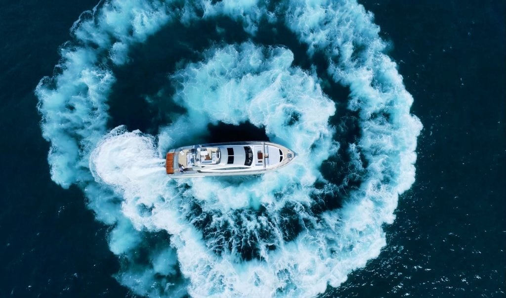 Motor yacht running in a circle on the water