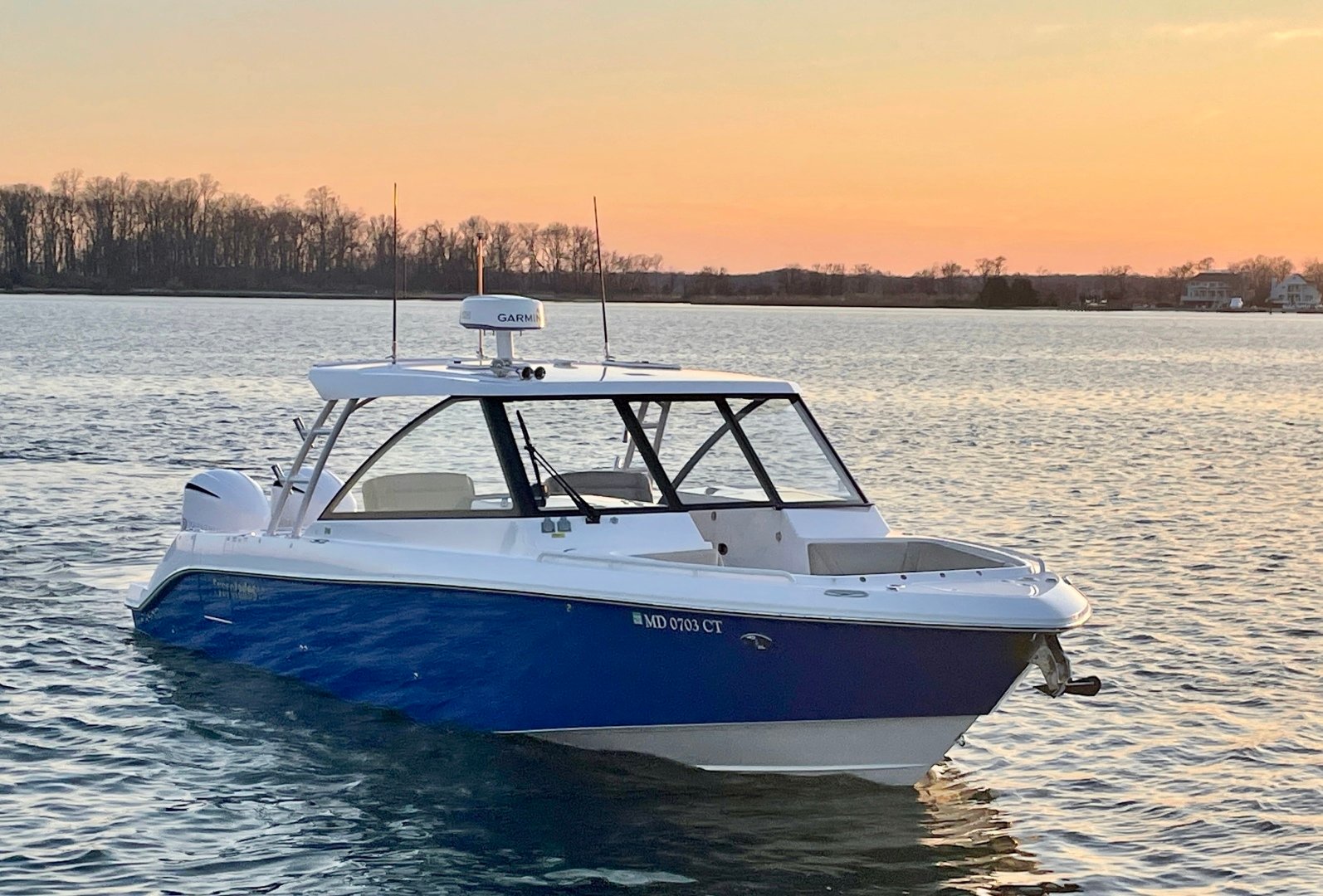 2019 Everglades 34 Dual Console sitting in the water at sunset.