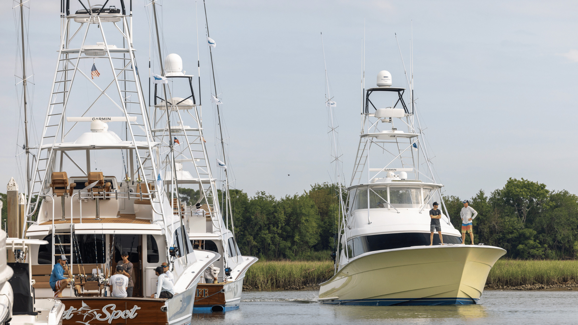 There is a yellow sportfish boat coming down a waterway in South Carolina. 